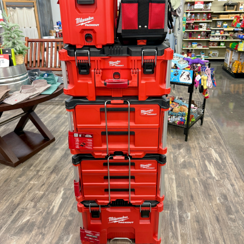 Stack of red Milwaukee tool boxes in a store setting