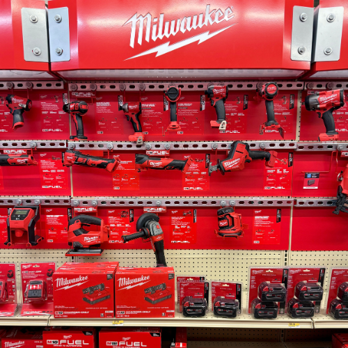 Display of Milwaukee tools and equipment on a store shelf.